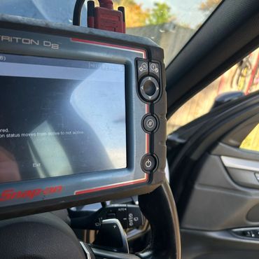 Snap-on diagnostic tool inside a BMW car.