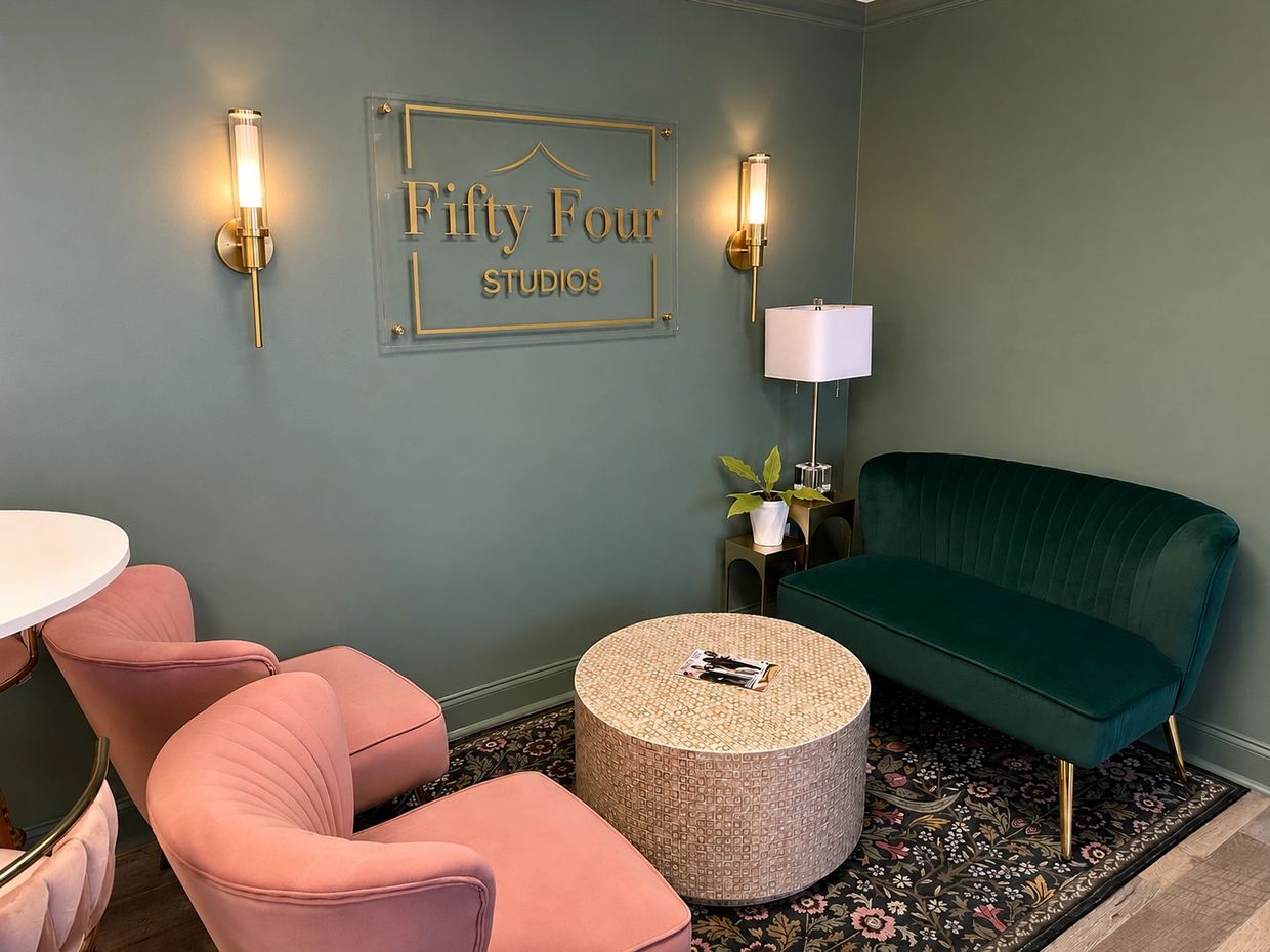 Modern lounge area with pastel and dark green seating at Fifty Four Studios.