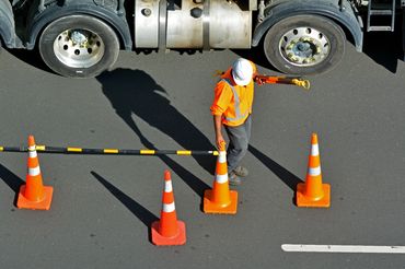 traffic safety cones with cone bars for traffic delineation, construction worker