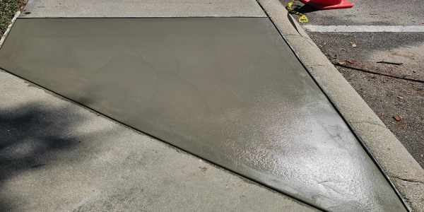 Freshly poured concrete section on sidewalk.