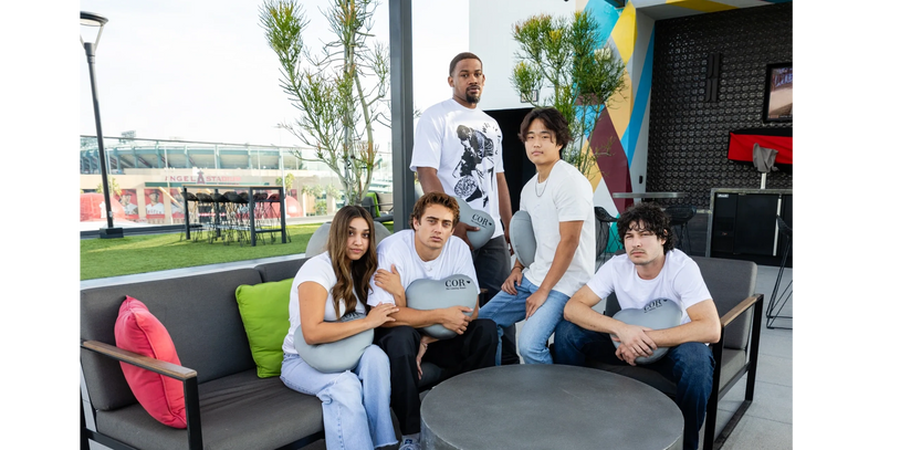 Open cafe image along with people holding gray color pillows