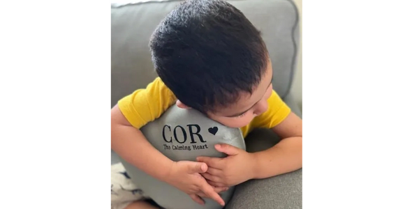 Top angle view of a boy watching at someone with pillow in hand