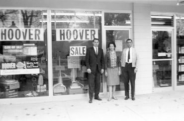 Former owners in front of Perry's when it was downtown.