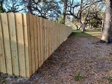 Stacked or board-on-board style wood fence.