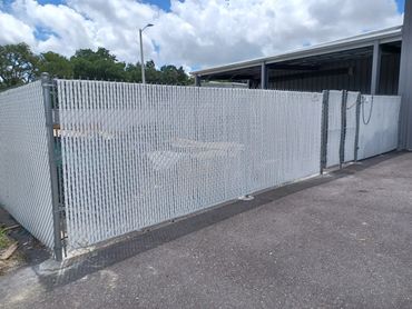 Galvanized 6' chain link fence with vinyl slats.