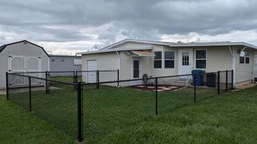 Black 4' chain link fence with a bottom rail.