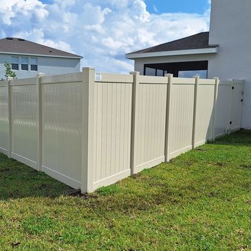 Tan vinyl fence.