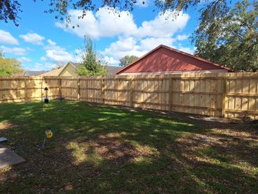 Stacked or board-on-board style wood fence.