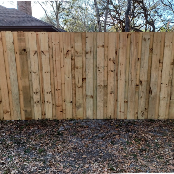 Stacked or board-on-board style wood fence.