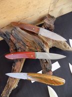 Damascas in 440-C in Bird/trout knife design. Shown with walnut and bloodwood.