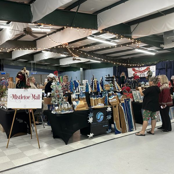 Indoor holiday market with festive crafts and decorations.