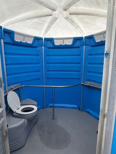 Inside view of a portable toilet with a raised seat.