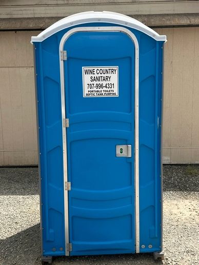 Blue portable toilet with sanitation company sign.