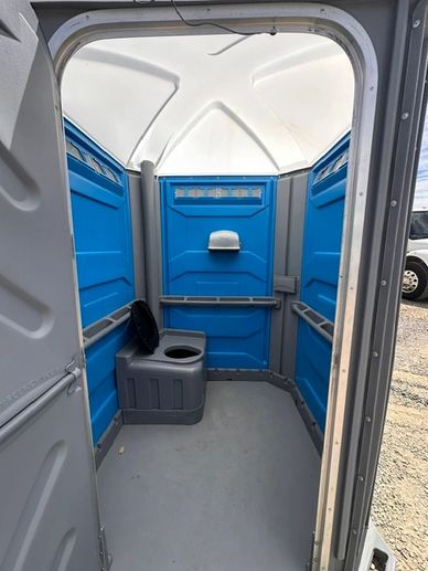 Inside view of a blue portable toilet.