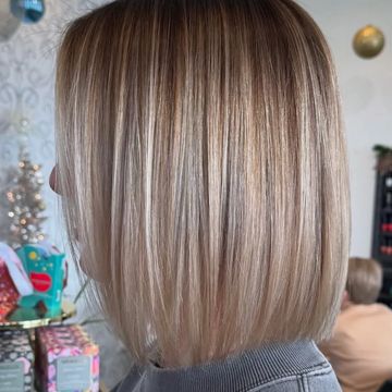 a classic bob haircut with soft blonde highlights