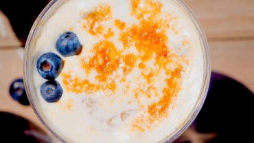 Creamy dessert with blueberries and caramel topping.