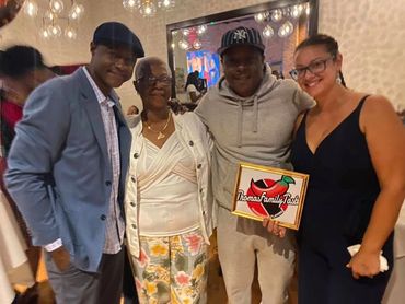 Jamal and Leslye Thomas pictured with Grandma Shirley and rapper Jadakiss at a pop-up shop.