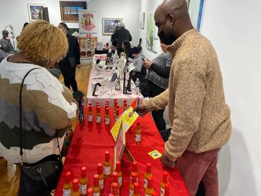 Jamal Thomas talks to a customer about Shirley's Scarborough Spice.