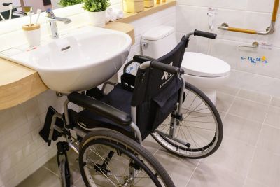 A wheelchair at an accessible bathroom sink