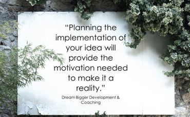 Piece of paper surrounded by plants with quote about getting motivation from planning.