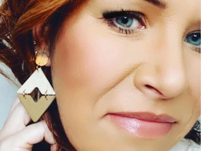 Dr. Lisa Senetar, designer and maker of PHBEAD JEWELRY wearing the two-tone Bailey earrings