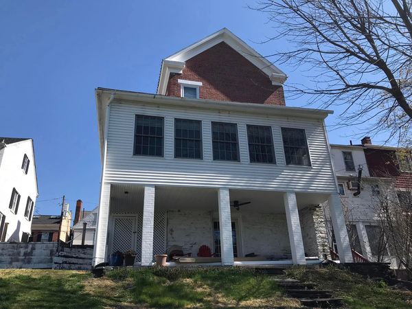 New seamless gutters and downspouts installed on a historic brick home in Bloomsburg, PA