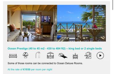Luxury ocean-view hotel room with balcony.