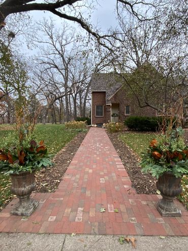 Residential Holiday planters decorated with spruce tops, ribbon, juniper, eucalyptus, magnolia.