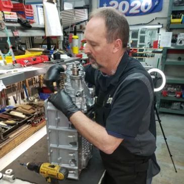 One our techs working on a Hellcat supercharger repair in our shop.
