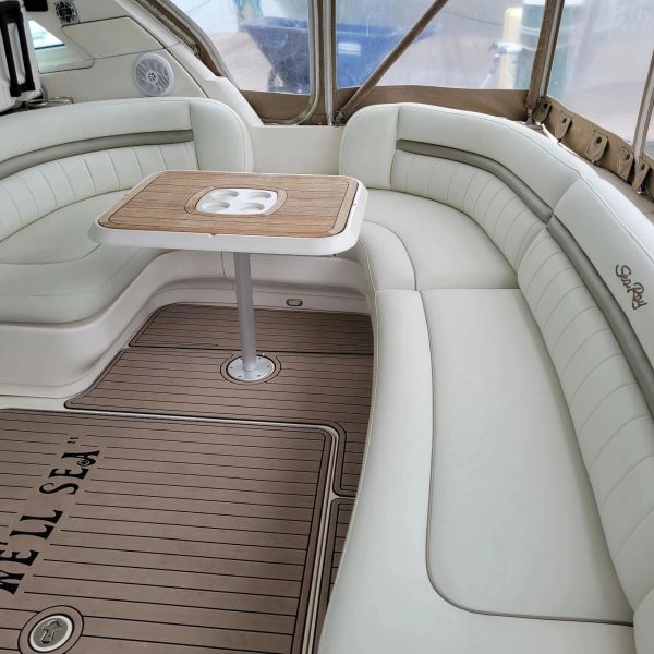 Luxurious seating area with wooden table on a boat.