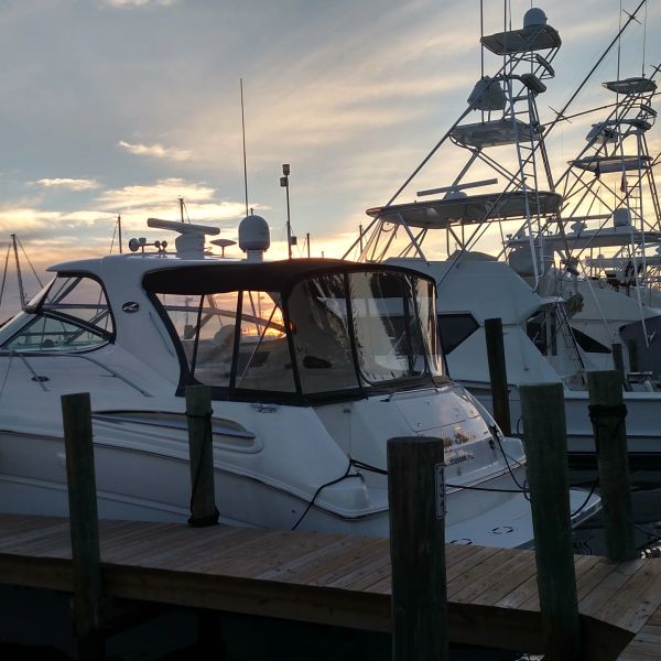 White boats docked at sunset.