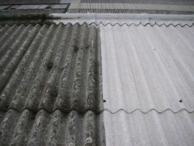 A roof with half cleaned and half dirty corrugated sheets.