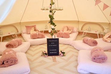 Luxury boho bell tent sleepover setup with cozy beds for birthday celebration in Derbyshire.