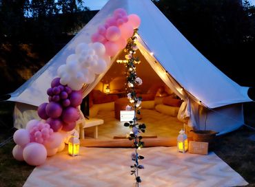 Night party bell tent with pink balloon arch in Derbyshire.
