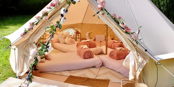 4m bell tent with pink cushions and garlands, perfect for sleepovers and birthdays in Leicestershire