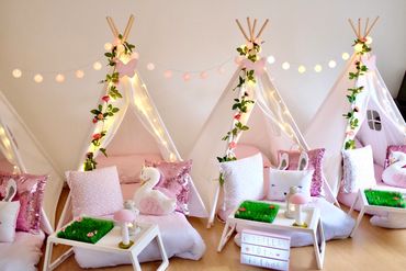 Luxury pink teepee sleepover setup with swan cushions by Slumber Buddiezzz for girls’ birthday.