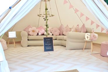 Beautiful boho bell tent in pastel pink, setup for a girls’ birthday party with sofa in Nottingham.