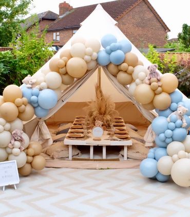 Teddy Bears Picnic bell tent with pastel balloon garland and rustic decor.