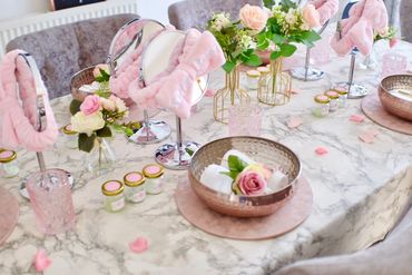 Elegant pamper party table with mini skincare jars for a girl’s spa celebration by Slumber Buddiezzz.