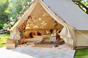 Safari bell tent setup with neutral tones and cosy decor.
