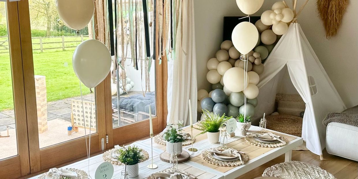 Boho Luxe picnic table with balloon garland setup for kids party in Derbyshire.