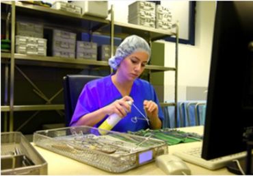 SPD Technician checking functionality during assembling instrument set for reuse.