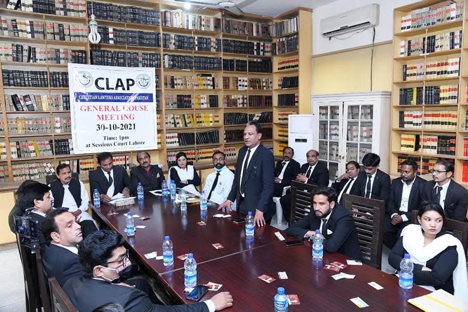 Lawyers attending the CLAP general meeting in a library setting.
