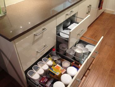 Open drawers with well organised crockery and Tupperware items  in Austin TX
