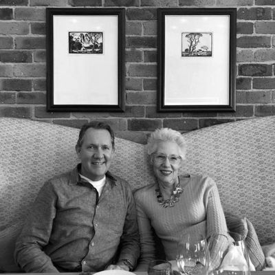 Hotel remodeling executive, Daniel Bezden with his wife Laura in elegant restaurant setting.