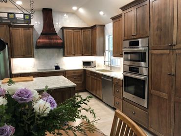 Kitchen Remodeling Company Atlanta GA  completed project with new wood cabinets and vent hood.