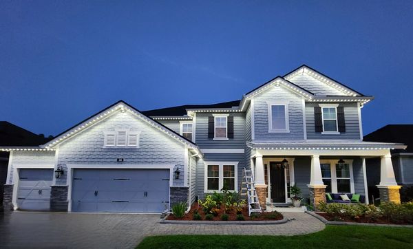 A Ponte Vedra home with facade lit up with over 200 led soffit lights at dusk by Glow Bug.