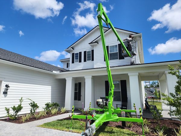 Glow Bug lighting installation on a house soffit with an aerial lift in Fruit Cove Florida.