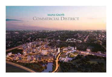Aerial view of Maple Grove Commercial District at dusk with illuminated buildings.