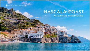 A scenic Amalfi Coast-inspired town on a coastal hillside under a clear blue sky.